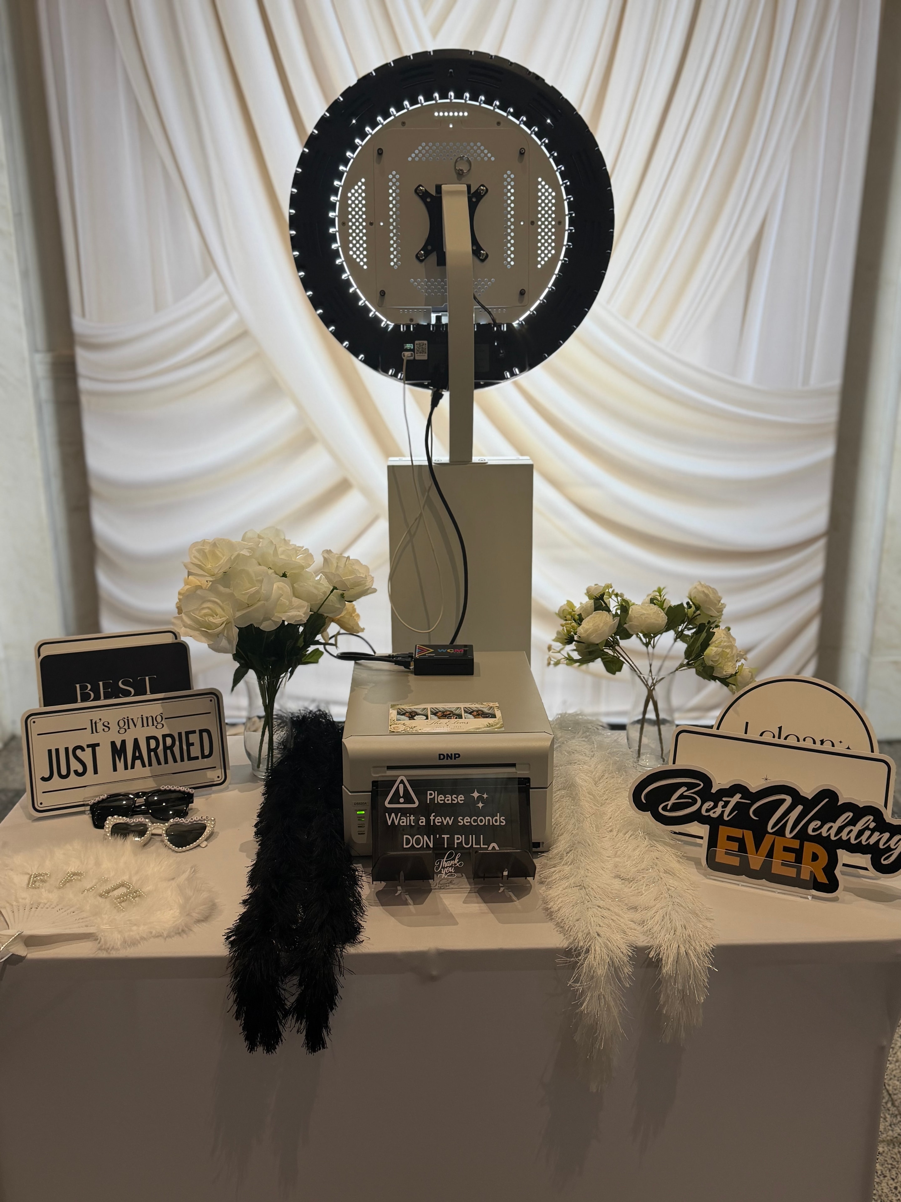 Glam Wedding Experience photo booth setup with ring light and wedding props